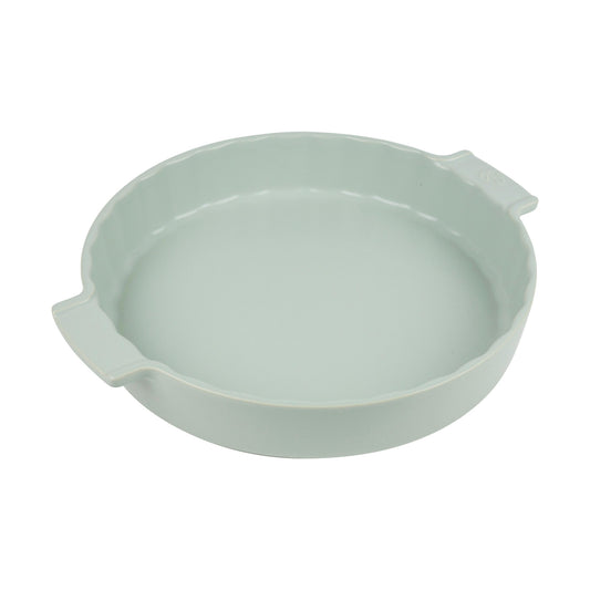 Light green ceramic dish with handles on a white background